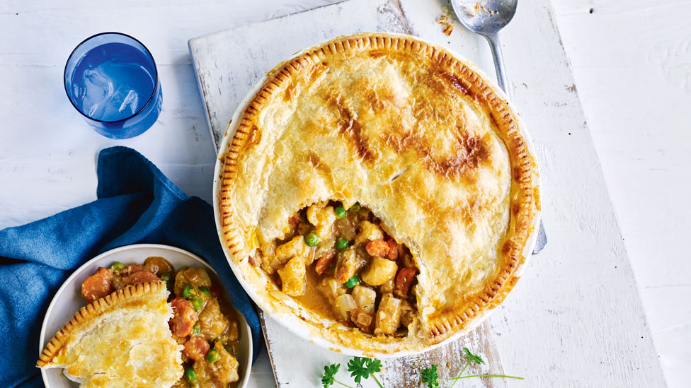 Two dishes of korma chicken and vegetable pie