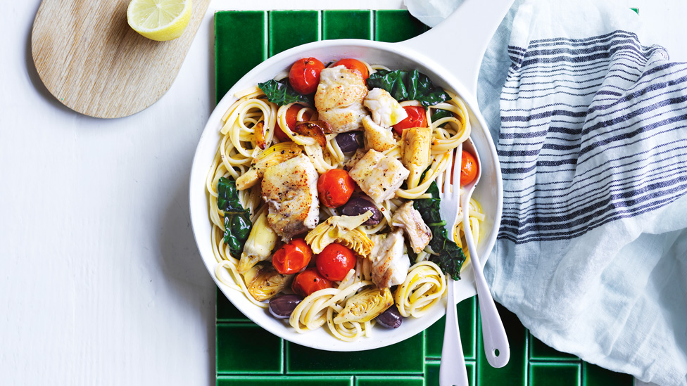 A bowl of linguine pasta with barramundi and olives