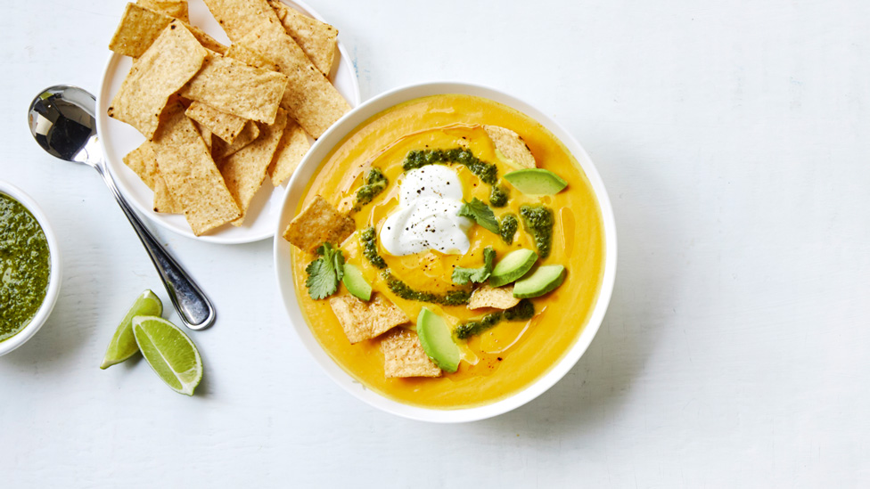 Mexican-style pumpkin soup topped with broken corn chips and coriander