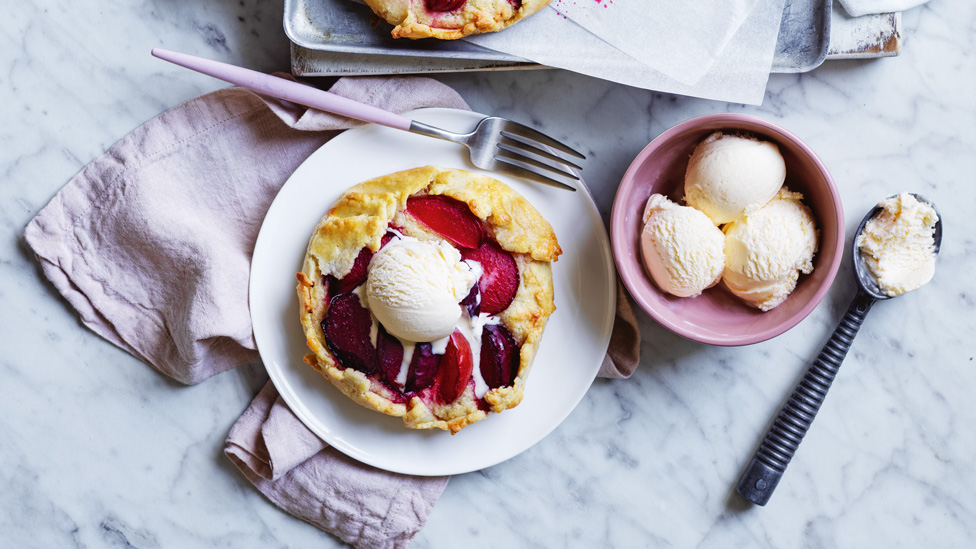 Mini Plum Crostatas on baking paper and small plate