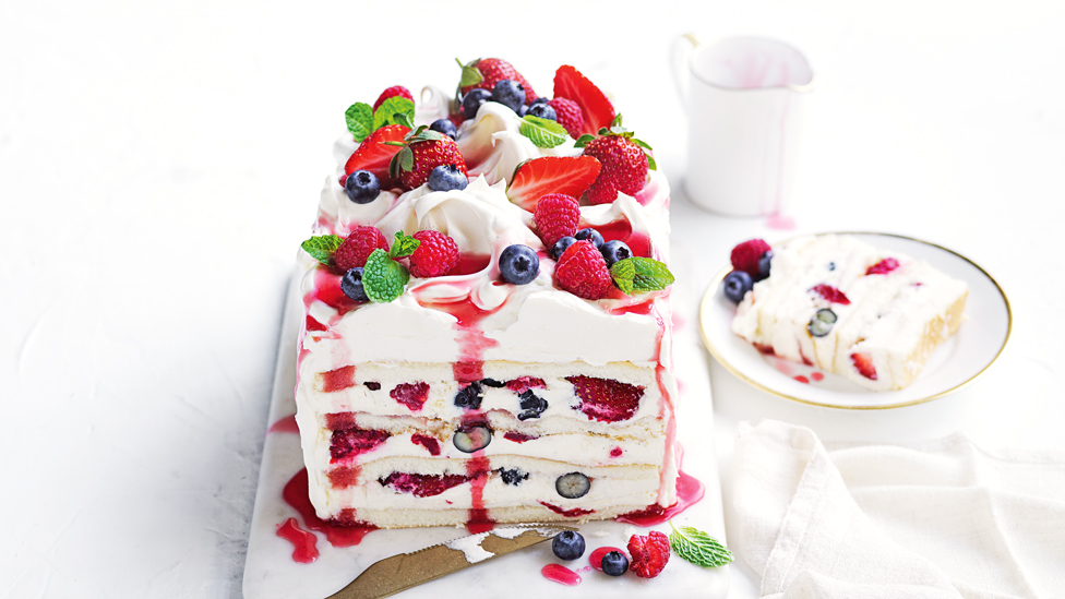 Mixed berry Pimm's cake sliced in half.