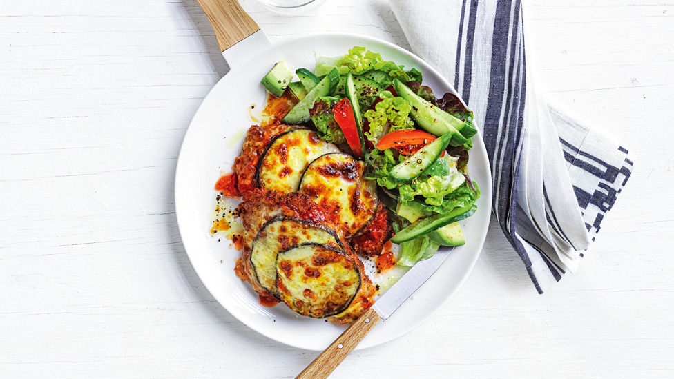 A pork and eggplant parmiagian served with a simple salad