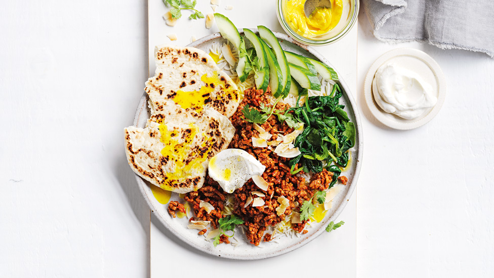 Tandoori lamb with rice, naan, cucumber and spinach