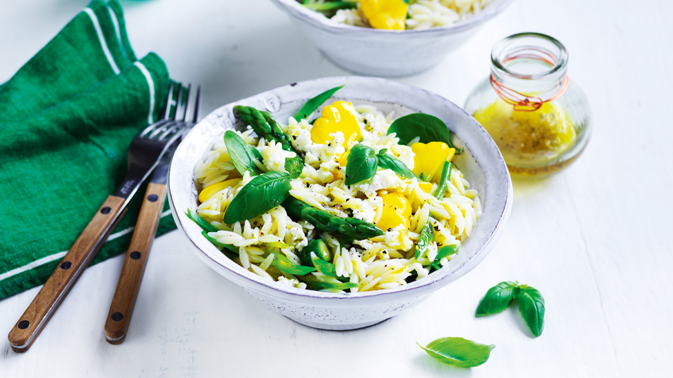 Risoni primavera with basil leaves and goat's cheese