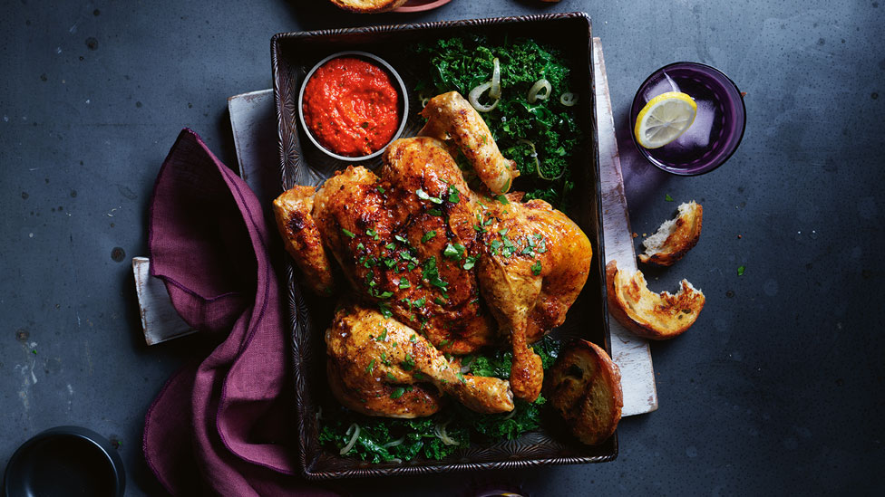 A crispy, roasted spatchcock chicken with chopped herbs and thick romesco sauce.