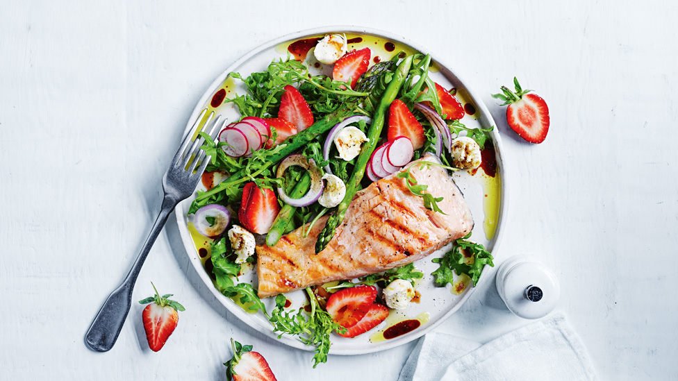 A dish of strawberry and asparagus salad with salmon