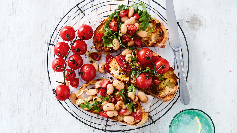 A bowl of tomato and bean bruschetta with cheery tomatoes