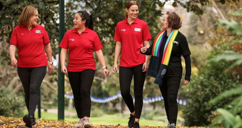 Coles Team members walking in nature smiling