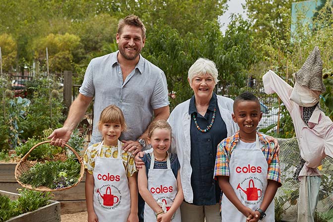 Curtis Stone and Stephanie Alexander with 3 children in a garden
