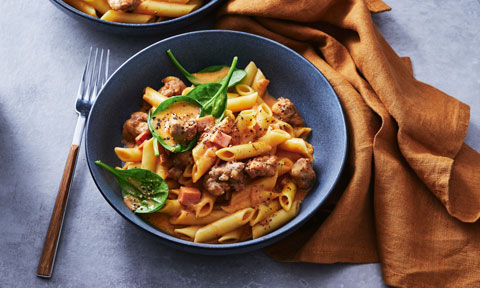 Creamy tomato pasta with sausage and bacon