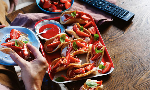 A tray of cinnamon tortillas with creamy filling and strawberry-mint topping.