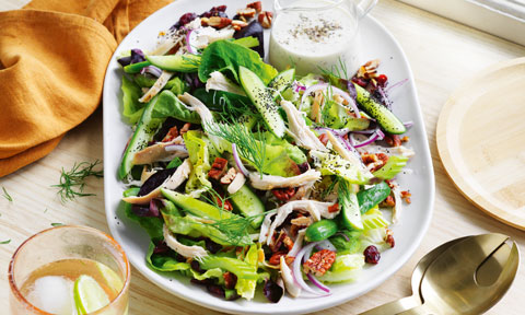 pecan cranberry and turkey salad on a white oval plate
