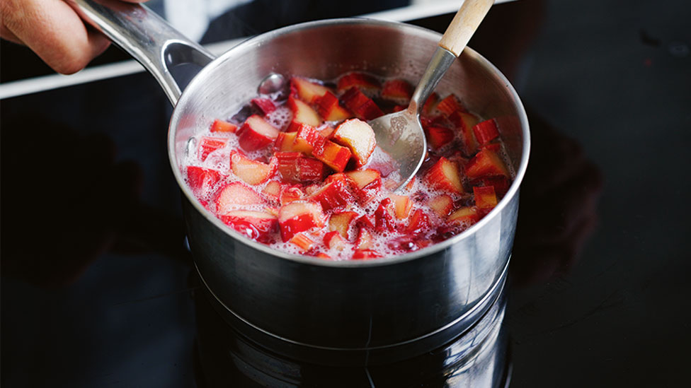 Rhubarb sugar syrup cooking in pan