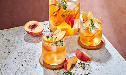 Peach iced tea drink with peach garnishes