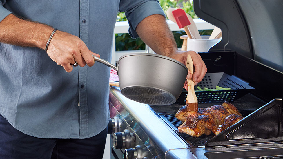 chicken on bbq being brushed with oil
