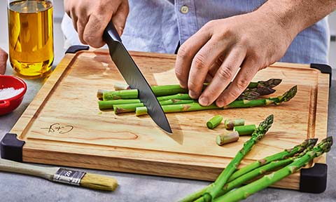 asparagus being cut on a chopping board
