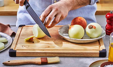 Onion being chopped on a cutting board.