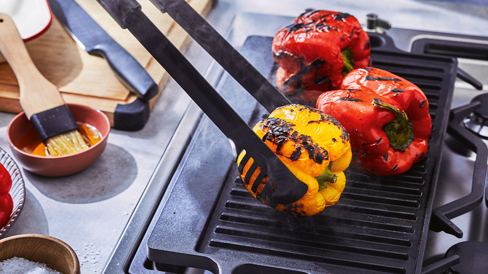 Capsicum being charred on a BBQ.
