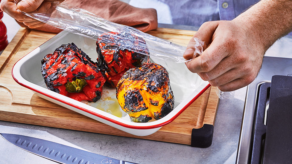 Capsicum in a tray being wrapped.