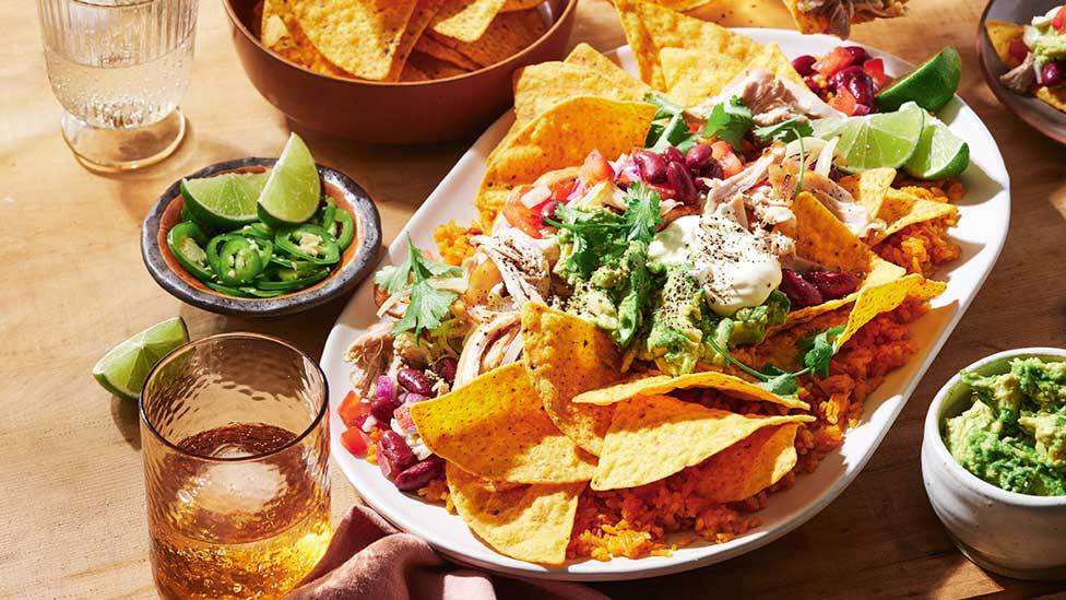 Tostitos platter on table with drinks and sides