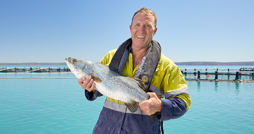 A fisherman holding a tuna