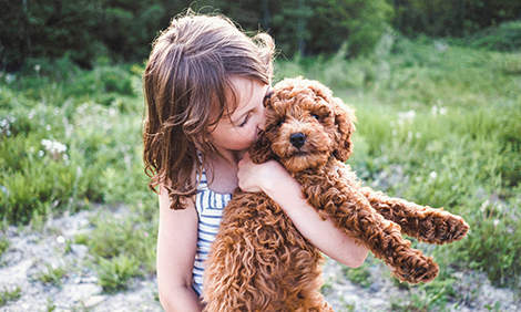 A girl hugging her puppy