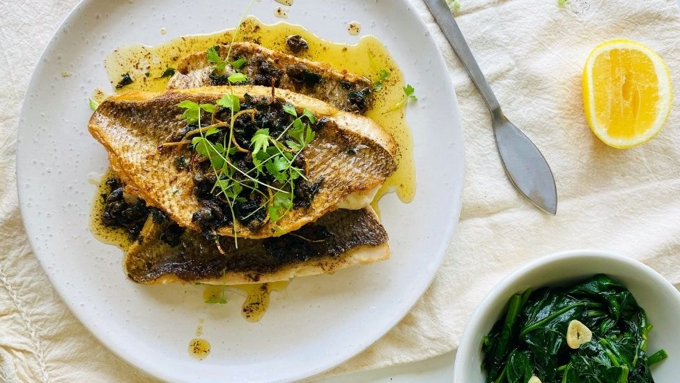 A plate with fresh snapper and lemon