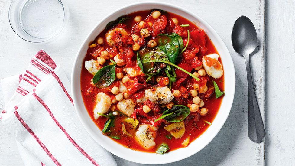 Fish and chickpea stew with spinach leaves