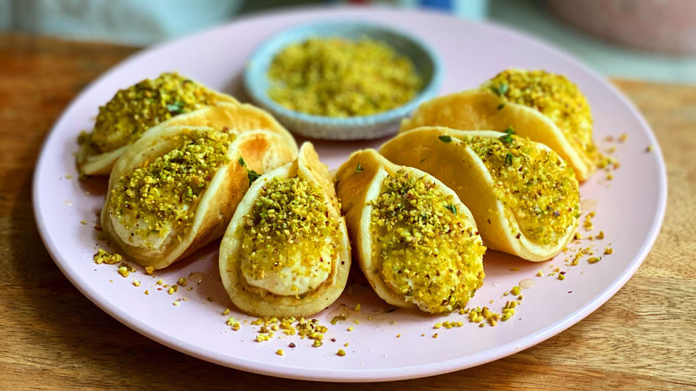 Six ricotta and pistachio pikelets with a small dish of honey and lemon syrup