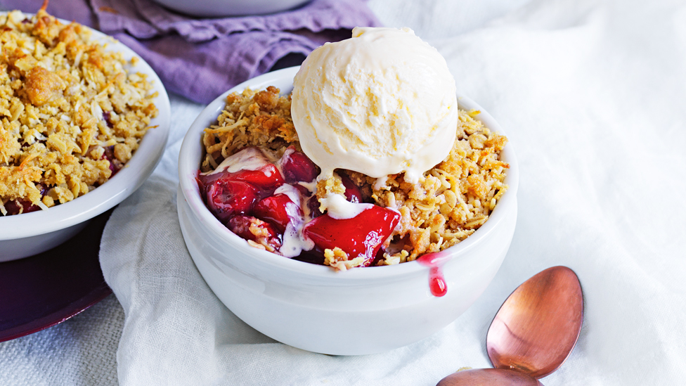 Morello cherry and apple crumble topped with an ice cream ball