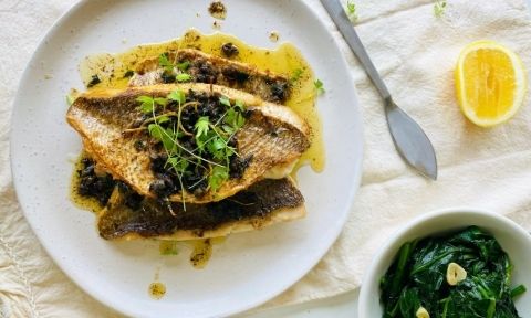 A plate with fresh snapper and lemon