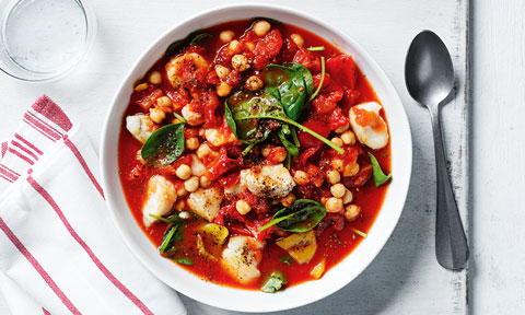 Fish and chickpea stew with spinach leaves