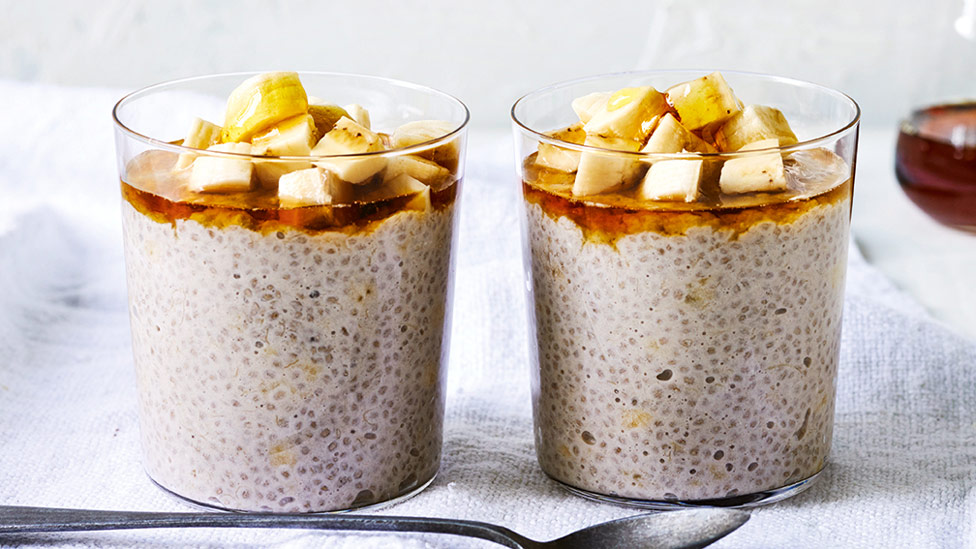 Two cups of banana chia pudding with chopped bananas on top