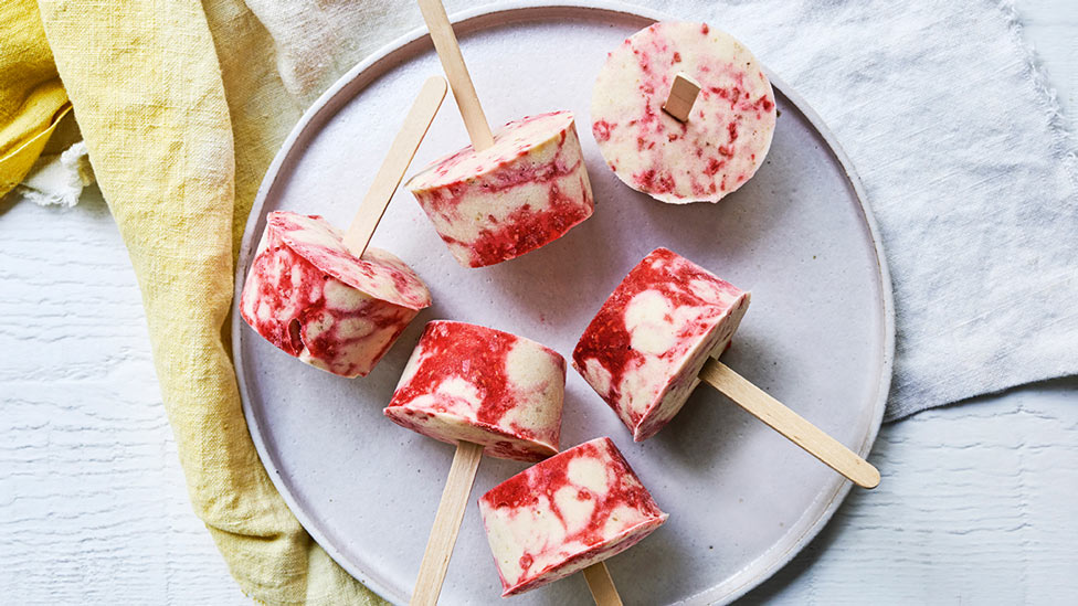 Six banana and raspberry nicecream pops served on a plate