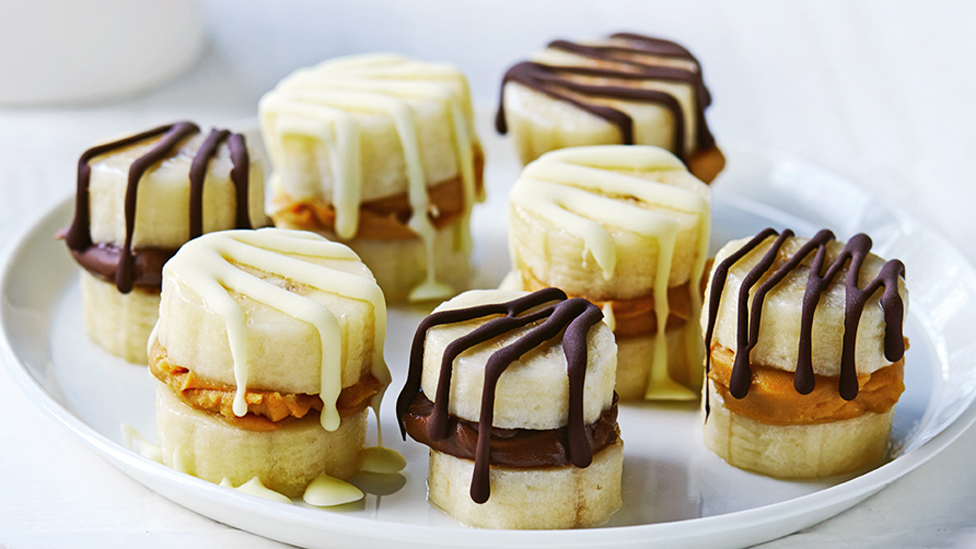 Seven frozen banana chocolate bites drizzled with chocolate 