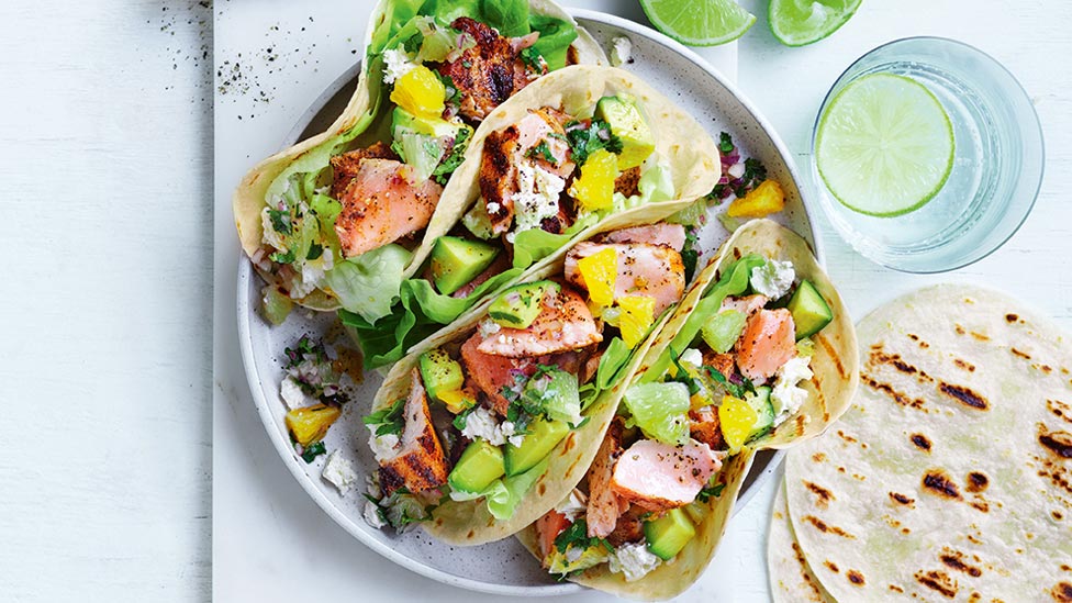 Four salmon tacos with lime and orange salsa