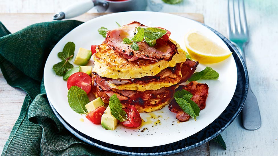 A dish of corn fritters with tomato and avocado salsa