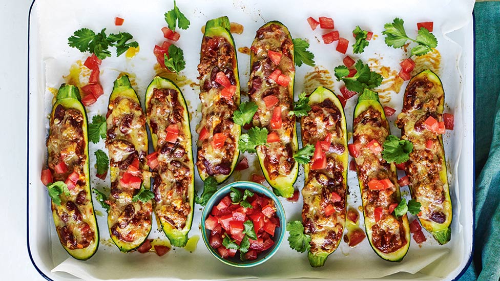 Eight Mexican style stuffed zucchini shells with tomato and coriander