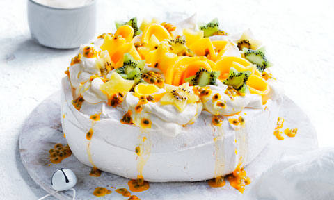 A traditional pavlova with passion fruit and kiwifruit on top