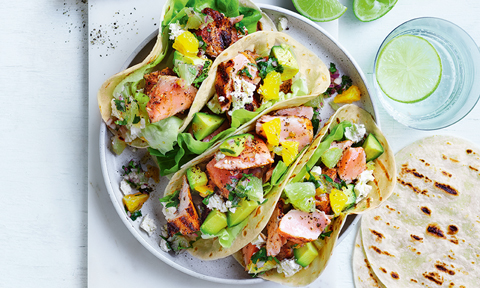 Four salmon tacos with lime and orange salsa