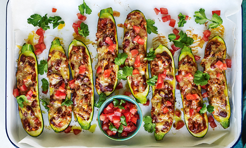 Eight Mexican style stuffed zucchini shells with tomato and coriander