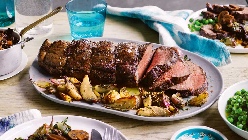 Roast beef with mixed mushroom sauce, shallots and peas