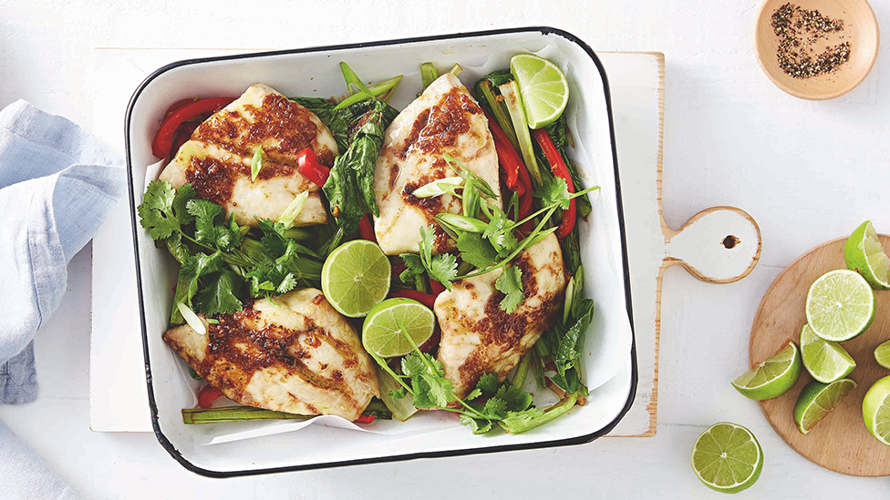 Snapper fillets in a baking tray with bok choy and red capsicum