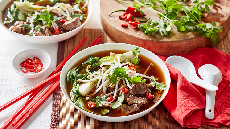 Beef and bok choy in a bowl of broth