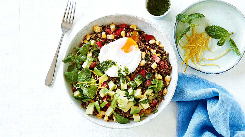 Quinoa salad with corn, tomato, avocado and coriander, topped with an egg