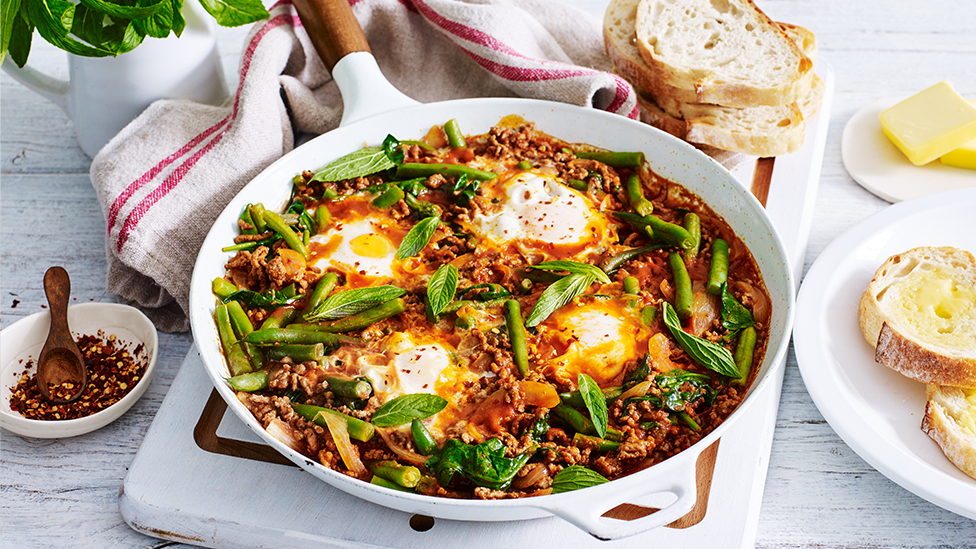 Baked eggs in spicy beef sauce