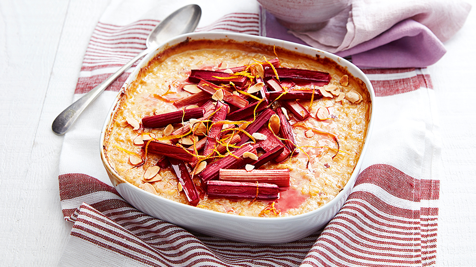 Large baking dish filled with rice pudding, topped with roasted rhubarb