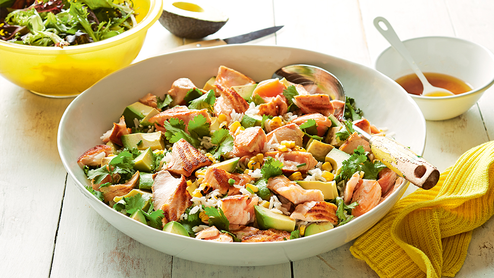 Salad of rice, salmon, avocado and corn in a bowl