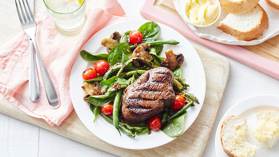 Barbecued steaks with grilled summer salad