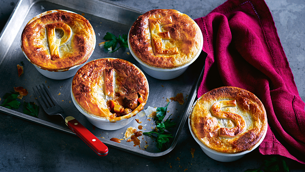 Four pot pies each with a different letter made from pastry on top spelling the word PIES